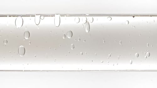 Liquid Bubbles Ascend Within Glass Tube