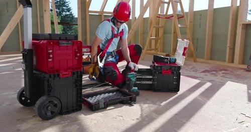 Construction Worker with Drill at a Home Construction Site