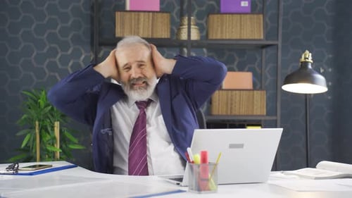Overworked Businessman Experiencing Stress at Office Desk