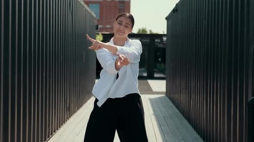 A Girl in Black and White Clothes Dances on the Street Contrast