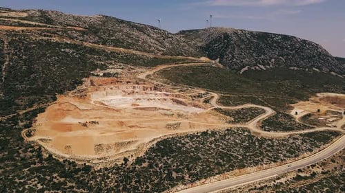 Aerial Shot of Open Pit Mine near Turbines