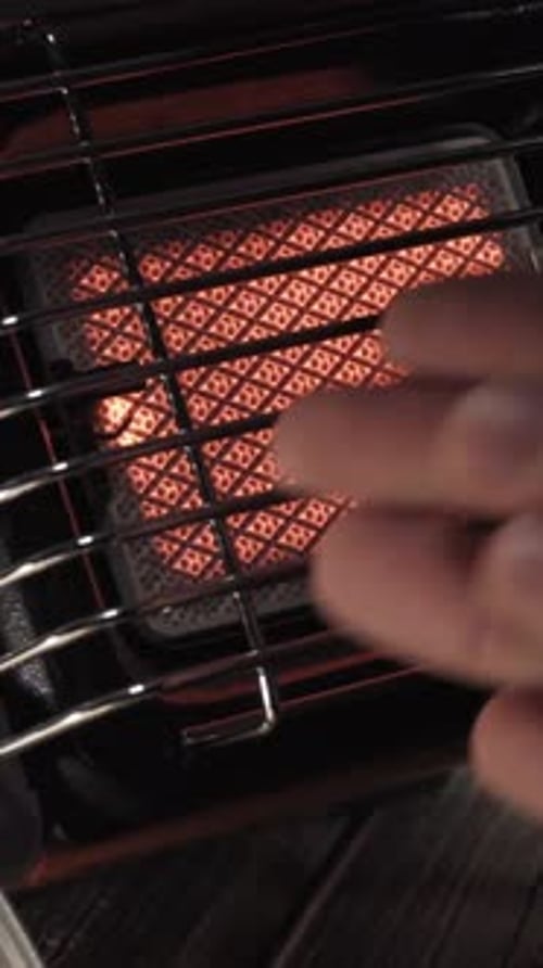 Portable gas ceramic heater for camping, warming my hands Vertical video.