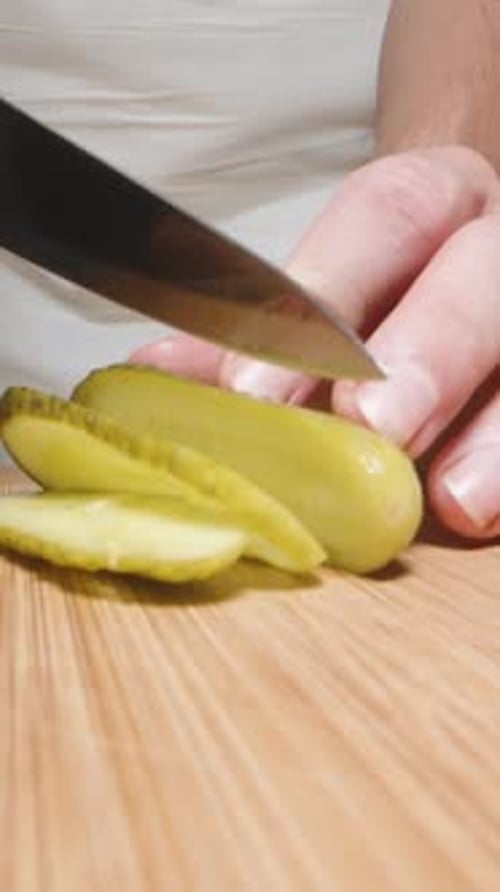 Slicing a Pickle on a Cutting Board