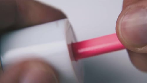 Pink Lip Gloss Wand Being Stored