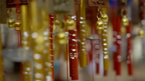 Close-up wind Chimes hangs on the porch of the house. Group of wind Chimes hanging on a festival