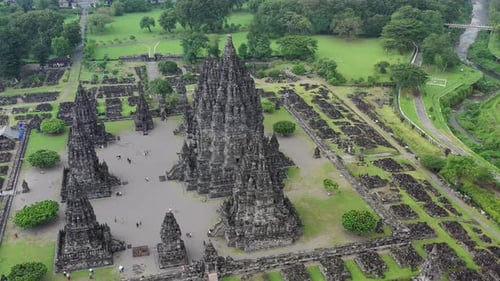 Prambanan Hindu temple in Yogyakarta, Indonesia with city behind, Aerial dolly out rising shot