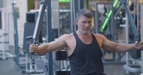 Gym Workout Butterfly Exercise Middle Aged Caucasian Man Trains His Pectoral Muscles in the Gym