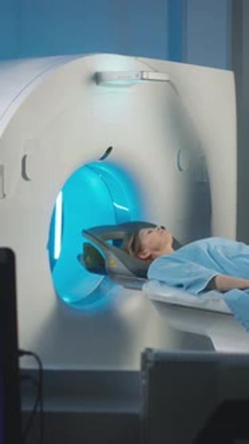 Woman Sliding into Brain MRI Capsule for Diagnostic Imaging Procedure