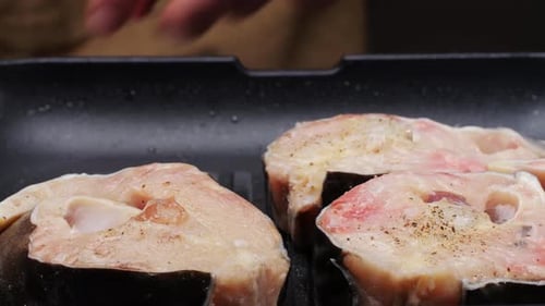Cooking Fillet Sturgeon Fish on Grill or Frying Pan with Oil Closeup Roast Healthy Food Concept Fry