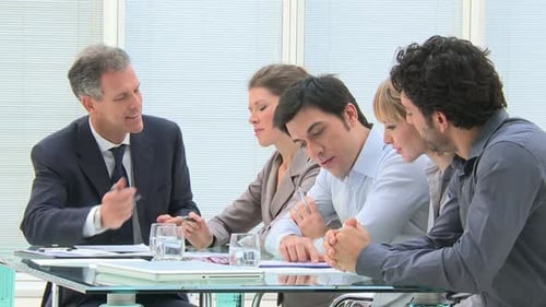 Mature Businessman Working and Discussing with His Colleagues at Office. Business Meeting