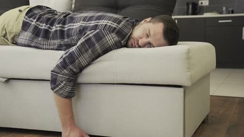 Man Sleeping on Sofa in Residential Interior