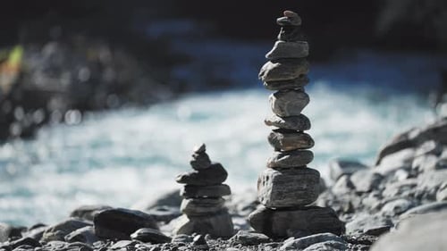 A picturesque scene of carefully arranged rocks, symbolizing harmony and peacefulness by a river.