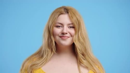 Real Curvy Woman Showing Yes Signal Nods Head Approve Positive on Blue Studio