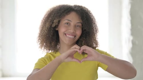 Young Woman Making Heart Shape With Hands