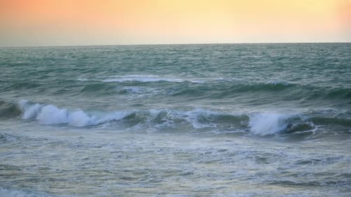 Small Waves on Sea or Ocean Against Backdrop of Sunset Dawn Over Sea Surface Autumn Seascape