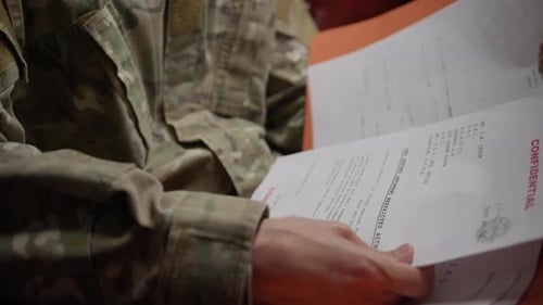 Military Personnel Reviewing Classified Documents