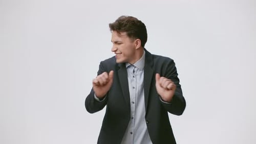 Enthusiastic Man Dances with Exaggerated Arm Movements
