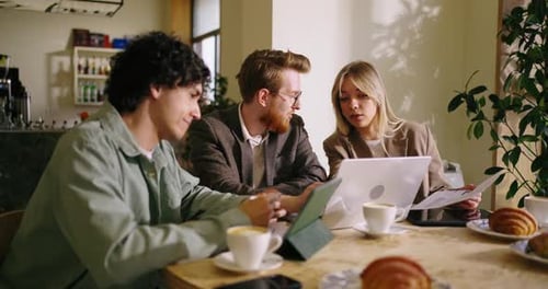 Business Owner And Partners Meeting In Cafe For Talking About Business Idea Startup And Strategy