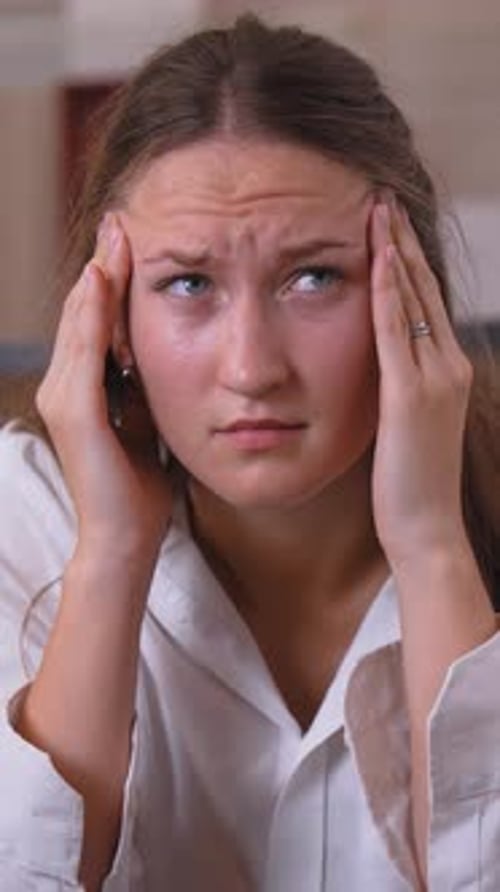 Woman Rubbing Temples with Headache Close Up