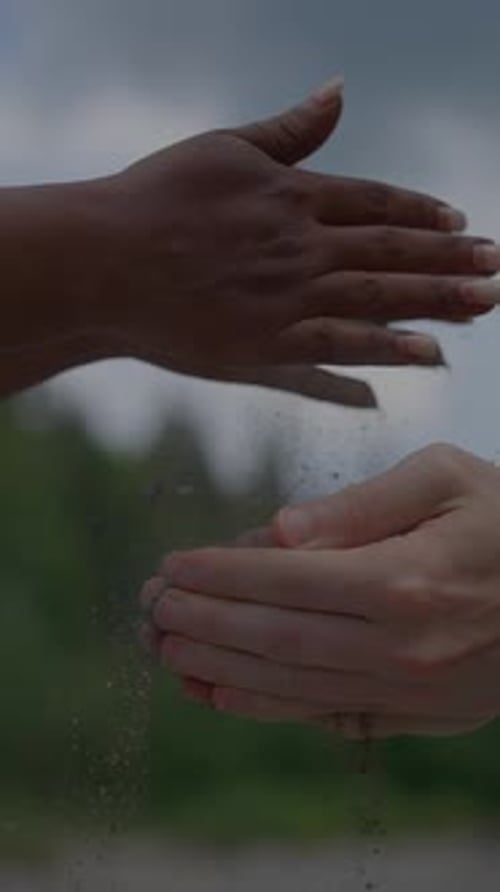 Unity Through Nature Hands Coming Together to Share the Sand in a Beautiful Landscape