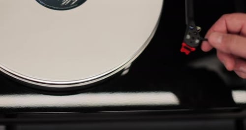Hand Placing Needle on a Vinyl Record