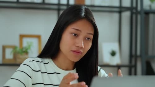 Woman Having a Video Conference Call at Home