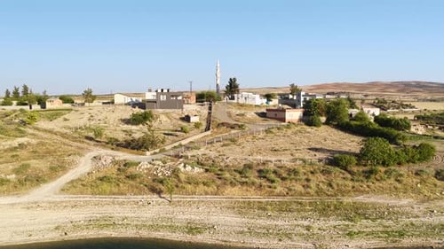 Aerial Video of Village Near Ancient River With Mountain Views