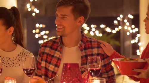 Friends Enjoying Salad and Wine at Cozy Dinner