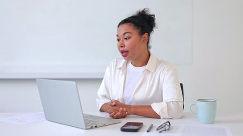 Woman on Video Call in Bright Office Setting