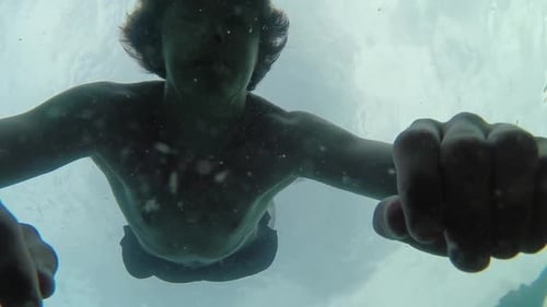 Young man drowning floats to surface no movement