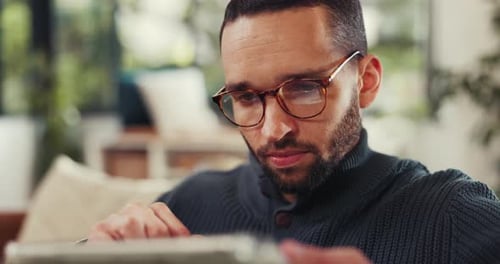 Bearded Man with Glasses Using Digital Tablet Indoors