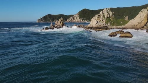 a Large Body of Water with a Rocky Shoreline in the Background