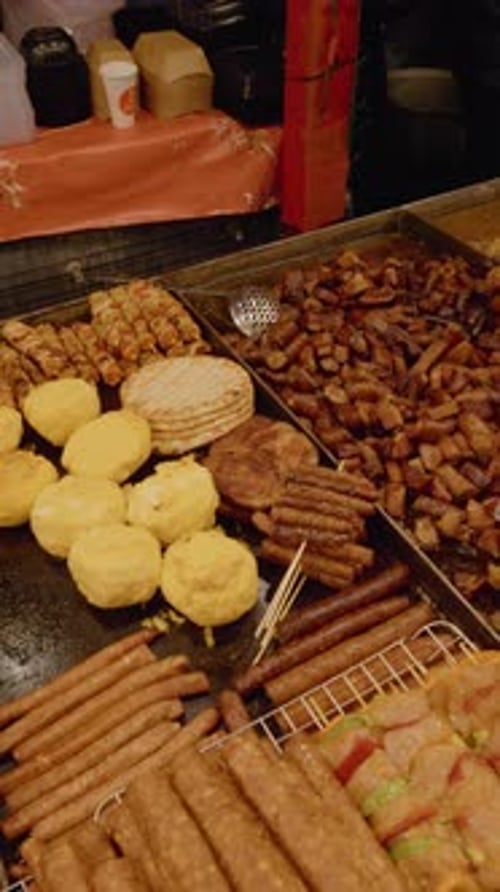 Vertical video Enjoying Romanian Christmas Market with Traditional Meats and Dishes