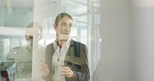 People, discussion and team at glass for planning, feedback and brainstorming at sticky notes