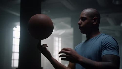 Professional Basketball Player Spinning Ball on Finger in Sport Club. Male Athlete