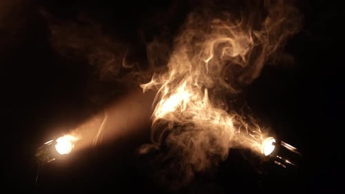 Bright Spotlights Beam From Professional Lighting Equipment Sparkle in the Dark with Floating Smoke