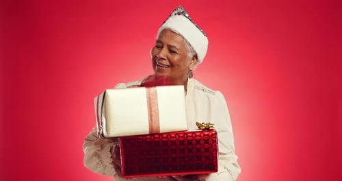 Christmas, gift and thinking with face of old woman in studio for reflection