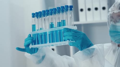 Female Scientist Holding Test Tubes in Lab
