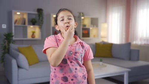 Girl child with toothache.