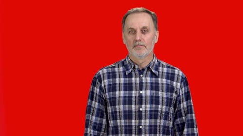Man Gesturing No In Front of Red Screen