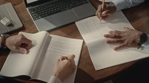 Men Reviewing and Signing Business Agreement, Shaking Hands