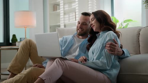 Couple Video Chatting on Laptop at Home
