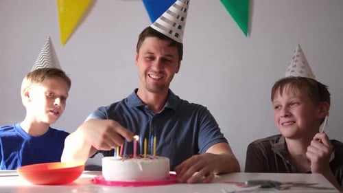 Family Celebrates Birthday with Cake and Candles