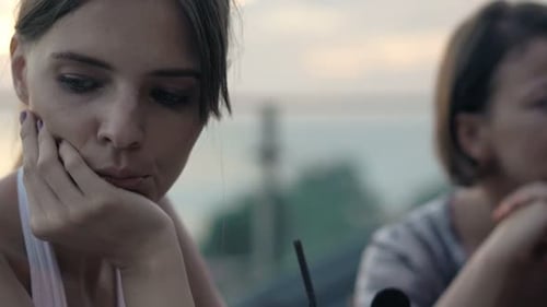 Two Offended, Bored Girlfriends Sitting in Cafe Adult