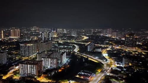 City at night with many buildings and a highway. Aerial KL night view