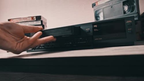 Insert VHS Cassette Into VCR Player