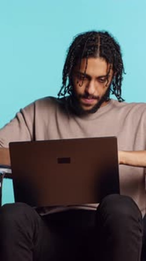 Vertical Video Man Composing Email Typing on Laptop Keyboard Studio Background