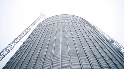 Large Metal Grain Silo on Overcast Day
