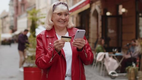 Senior Woman Using Credit Bank Card Smartphone While Transferring Money Purchases Online Shopping