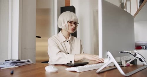 Young Business Woman in Glasses Working in Office Interior on Pc on Desk Typing